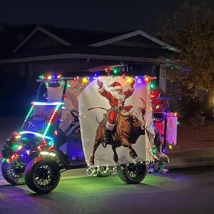 Customer photo of Rodeo Santa bull riding Christmas design displayed on decorated vehicle with holiday lights
